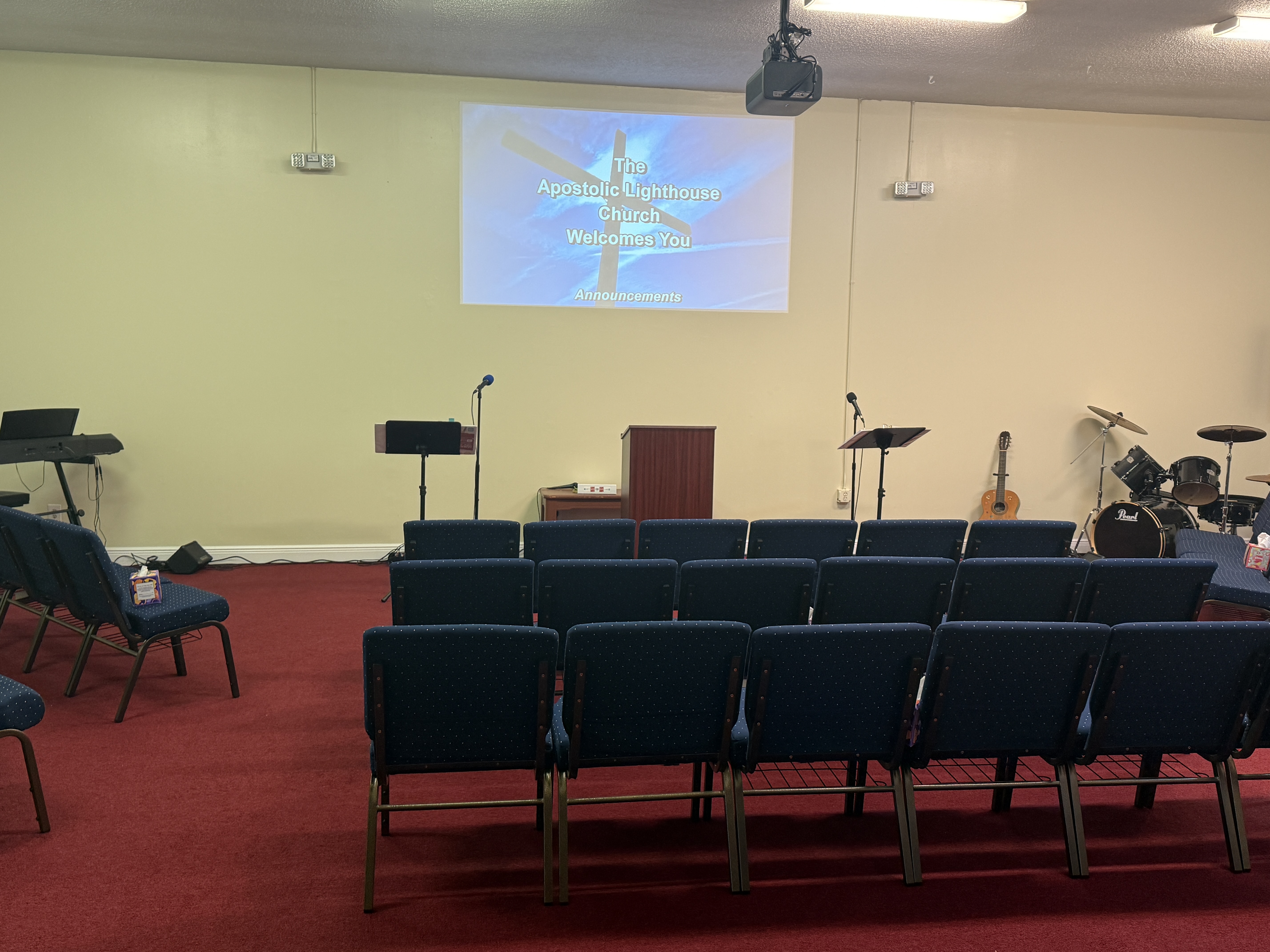 Inside the church sanctuary, with rows of seats facing the pulpit
